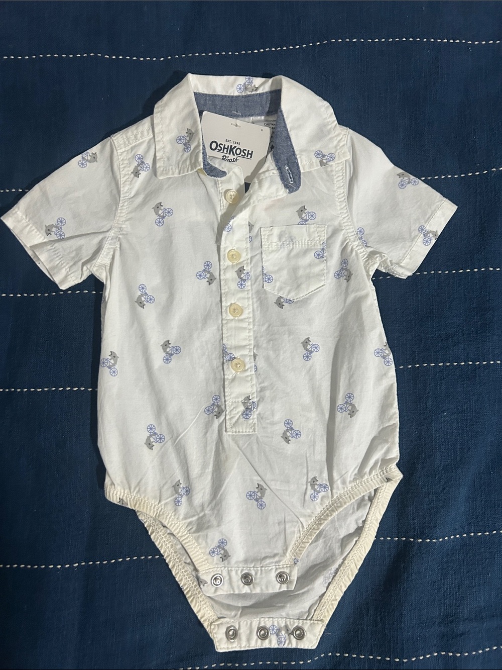 OshKosh B'gosh White Short-Sleeve One-Piece with Light Blue Sharks on bicycle